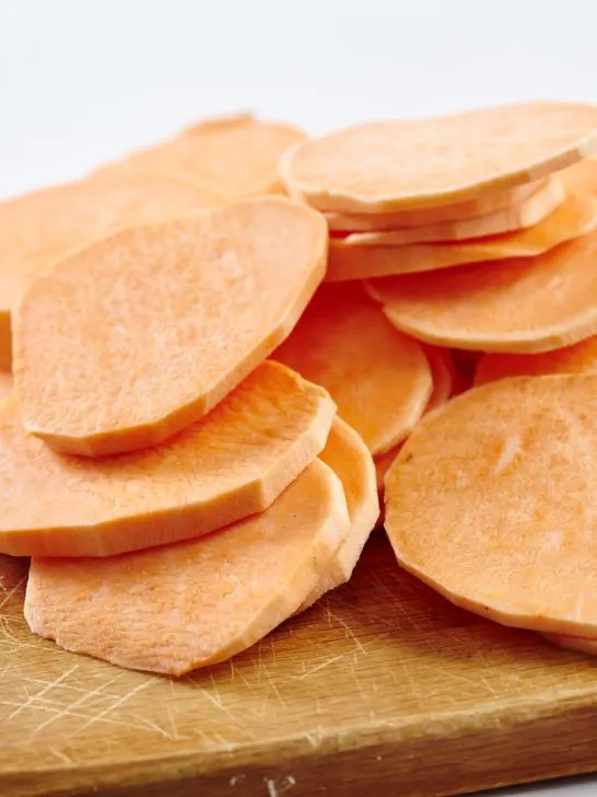 sliced sweet potatoes for dogs on cutting board 