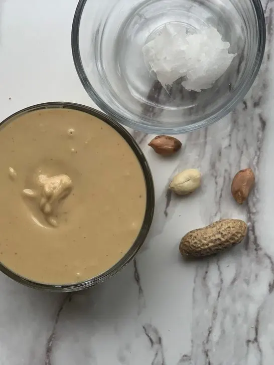 raw peanuts and coconut oil is all you need to make creamy homemade peanut butter for your dog